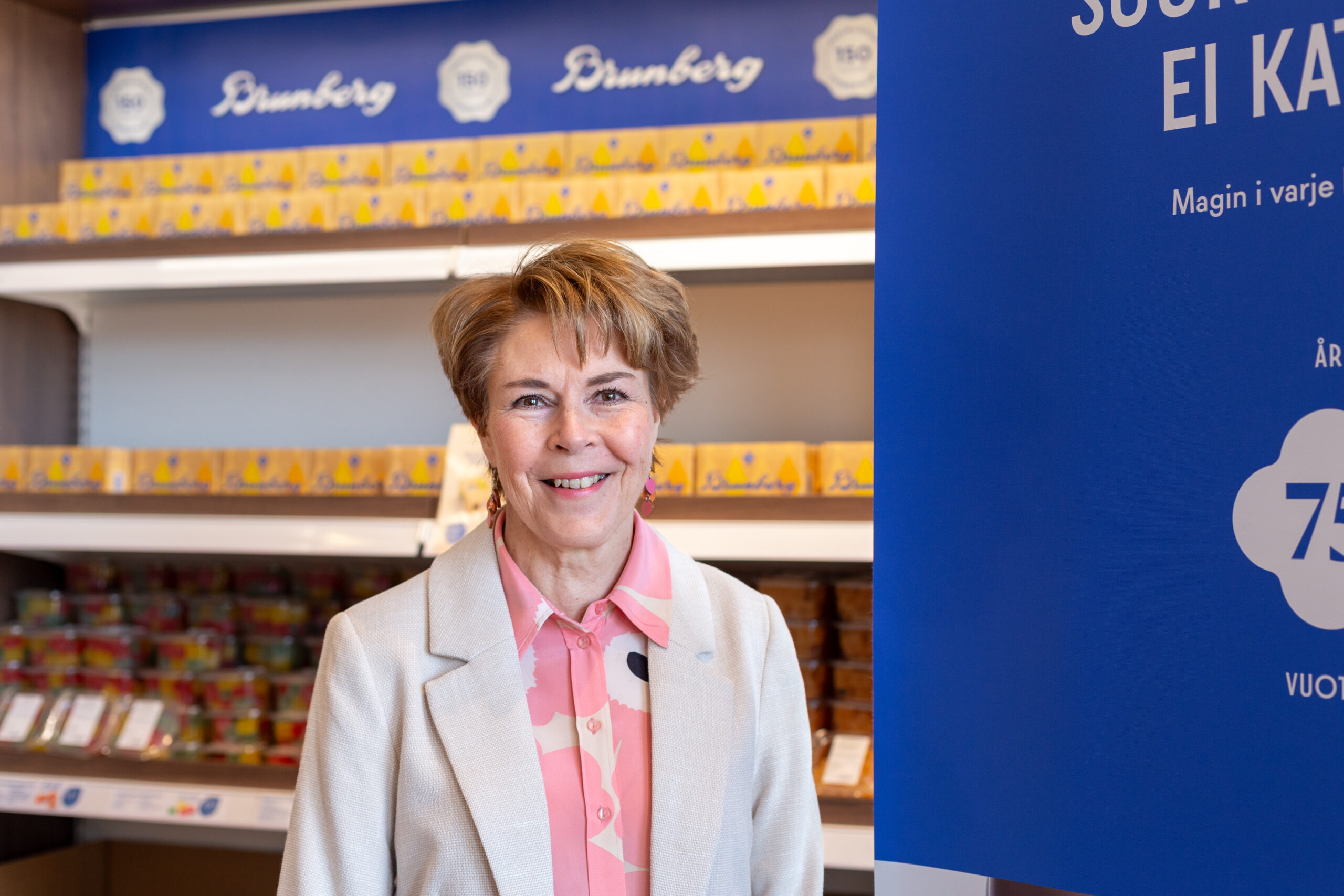 A woman posing inside a candy store.